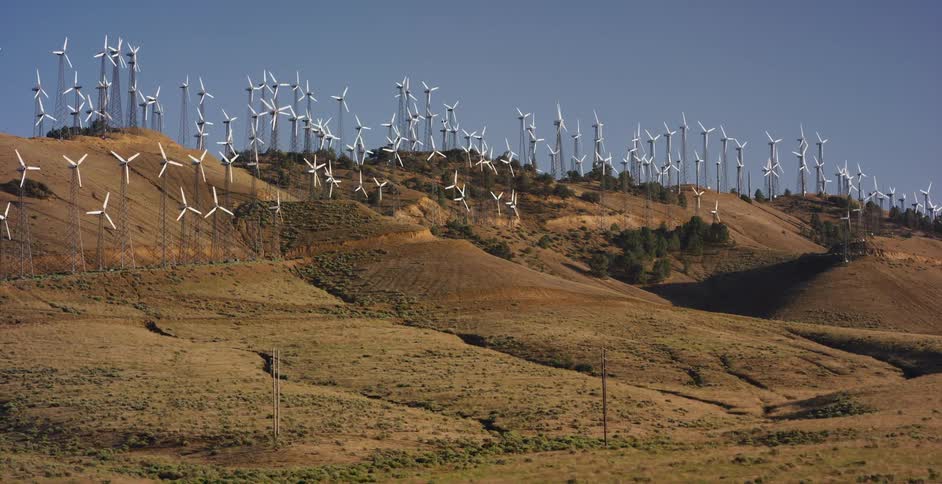 A massive wind farm generates renewable energy as dozens of turbines spin atop the dry, rolling hills of Tehachapi, California