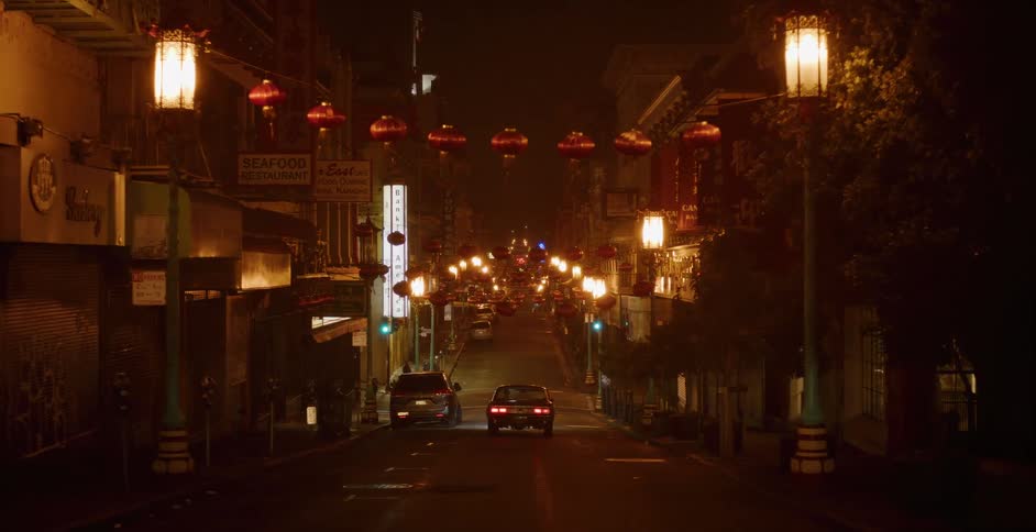 A slow zoom down a deserted, lantern-lit street in Chinatown on a foggy night