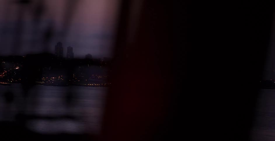 A slow pan across the San Francisco Bay at dusk reveals Alcatraz Island, the Golden Gate Bridge, and the illuminated city skyline