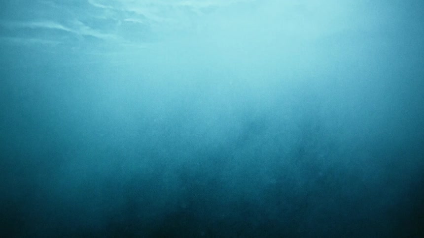 A mysterious white cloud billows and expands underwater, turning the dark water murky in slow motion