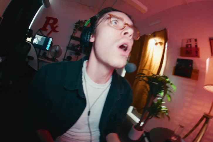 Wide-angle fisheye shot of an expressive gamer grabbing a controller and getting immersed in a video game at home