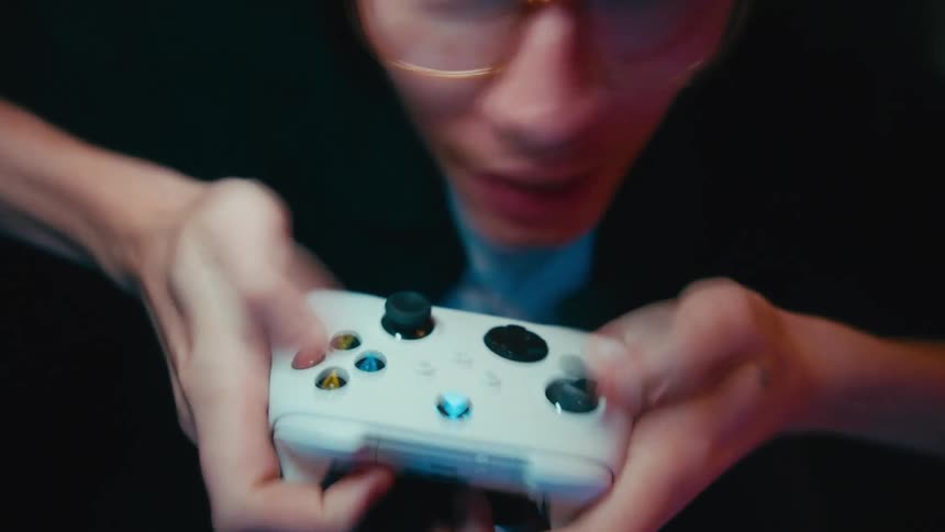 An intense close-up shot of a gamer's hands flying across a controller during a fast-paced video game