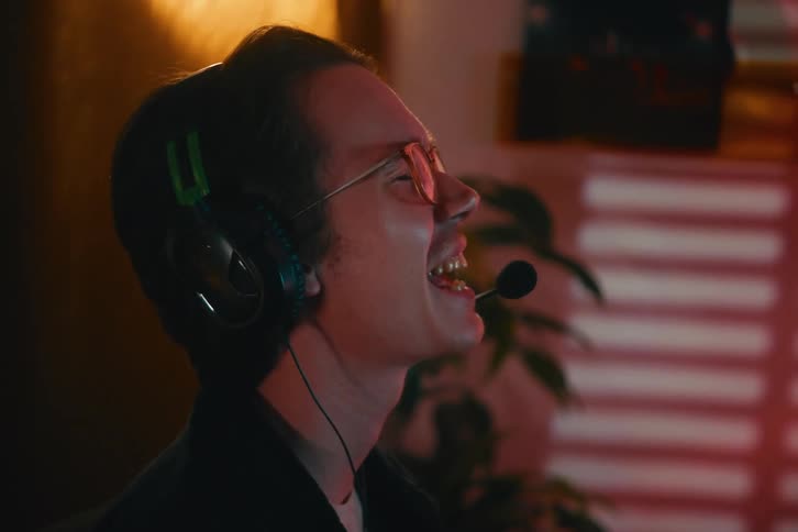 A young gamer in a headset experiences a rollercoaster of emotions, from the elation of a potential win to the crushing disappointment of defeat
