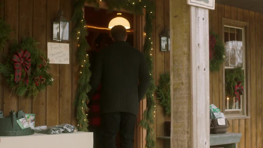 People walk towards a home and enter