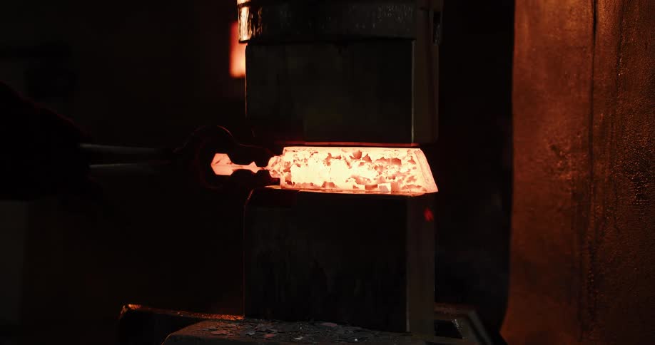A blacksmith shapes a glowing hot ingot with a powerful mechanical press, sending sparks flying in a dark forge