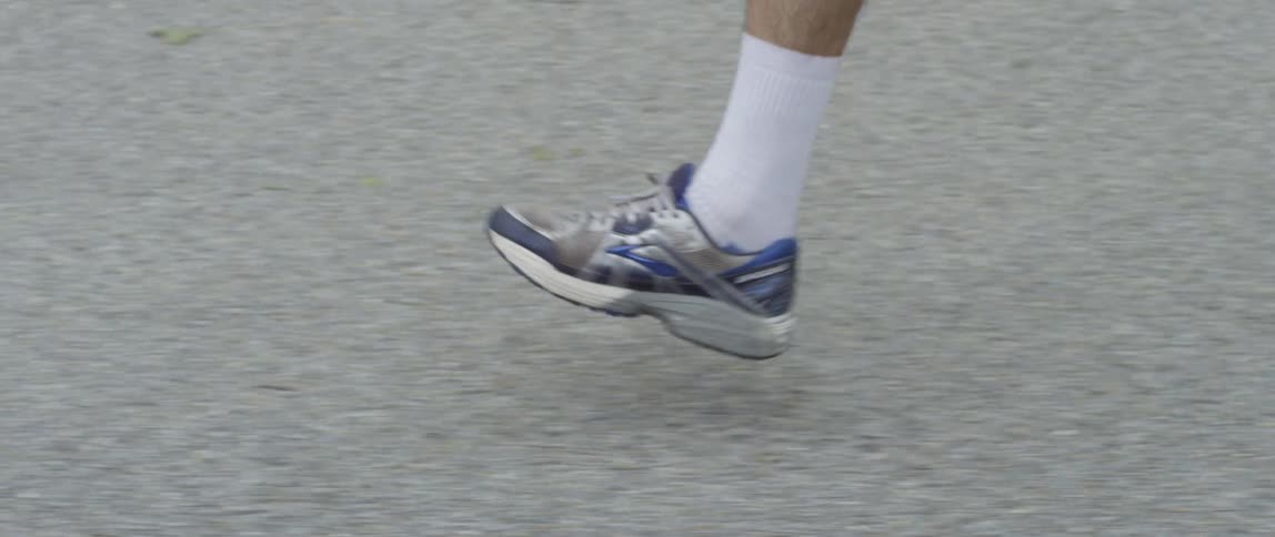 Sneakered feet running on pavement