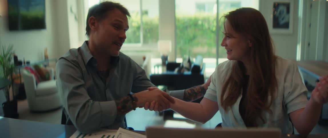 Happy business partners shake hands to celebrate a successful agreement in a bright, modern office