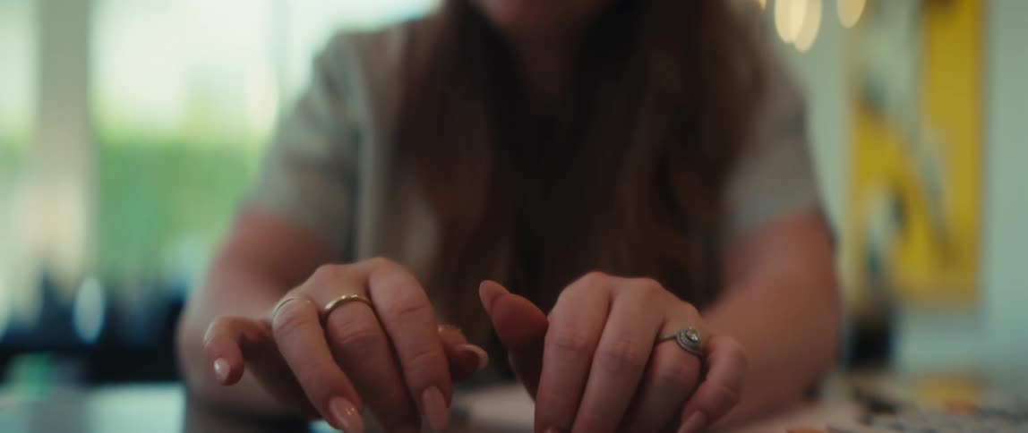 A woman makes a compelling point by pointing her pen directly at the camera during a serious conversation