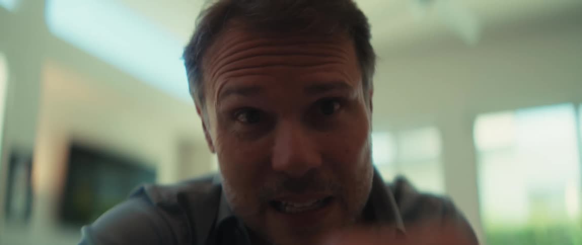 Close-up slow motion of a man and woman engaged in an intense and emotional conversation in a bright, modern room