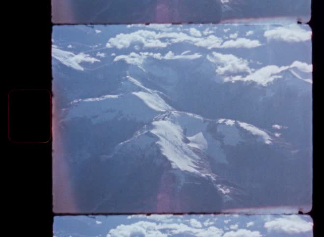 A scan of old 8mm film shows a stunning birds-eye view of a snowy mountain landscape