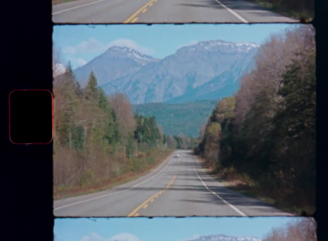 A retro film strip shows a scenic drive on a highway leading towards towering, snow-capped mountains on a sunny day