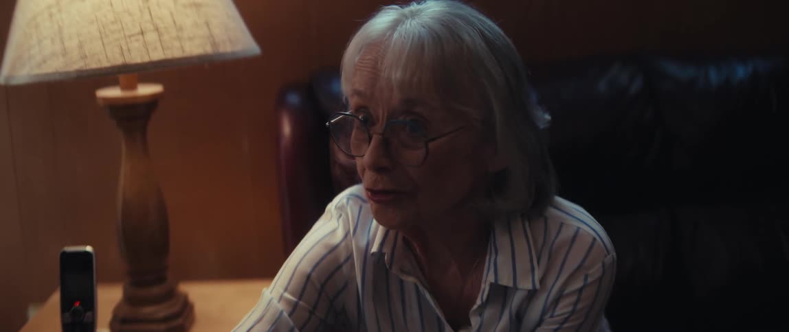 Slow motion shot of a caring nurse visiting with an elderly couple in their home