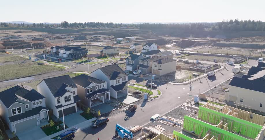 Subtle orbit over a new suburban housing development with homes in various stages of construction