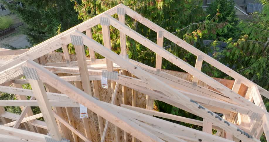 Low pass above newly installed wood roof trusses on a new house under construction