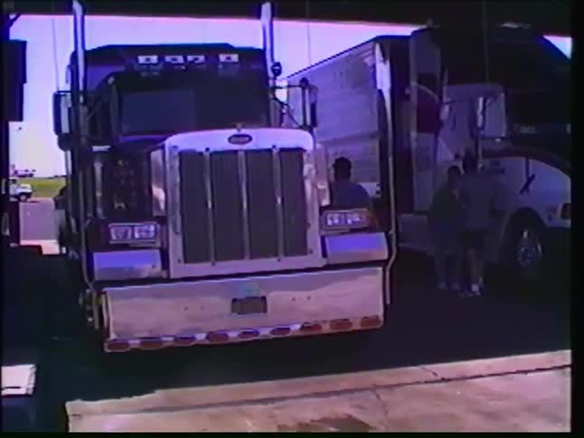 Vintage VHS footage shows various semi-trucks, including a Yamaha racing team hauler, at a truck stop gas station