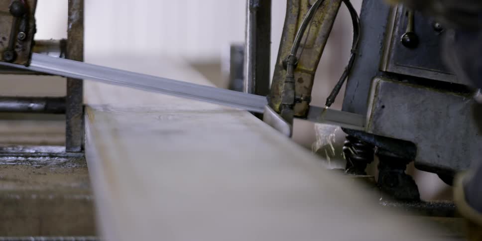 A saw cuts through a piece of material