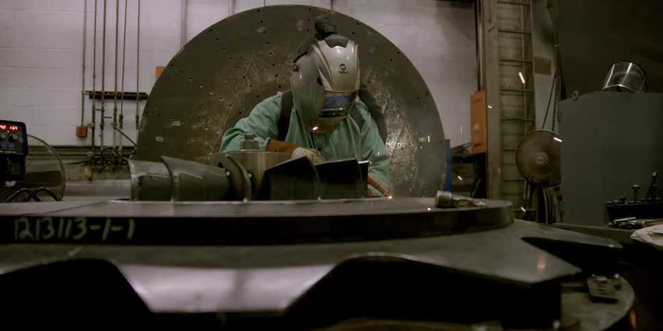 A welder works in a factory