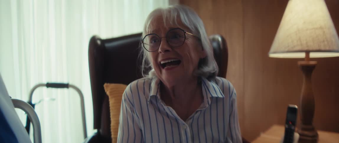 An elderly woman's emotions change from happy to concerned while talking with her doctor during an in-home medical consultation