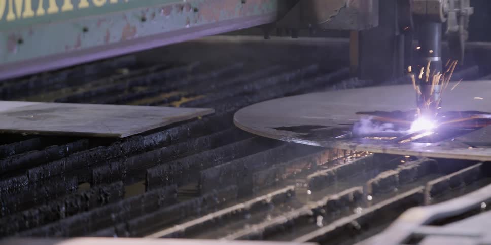 A machine carves metal and causes sparks