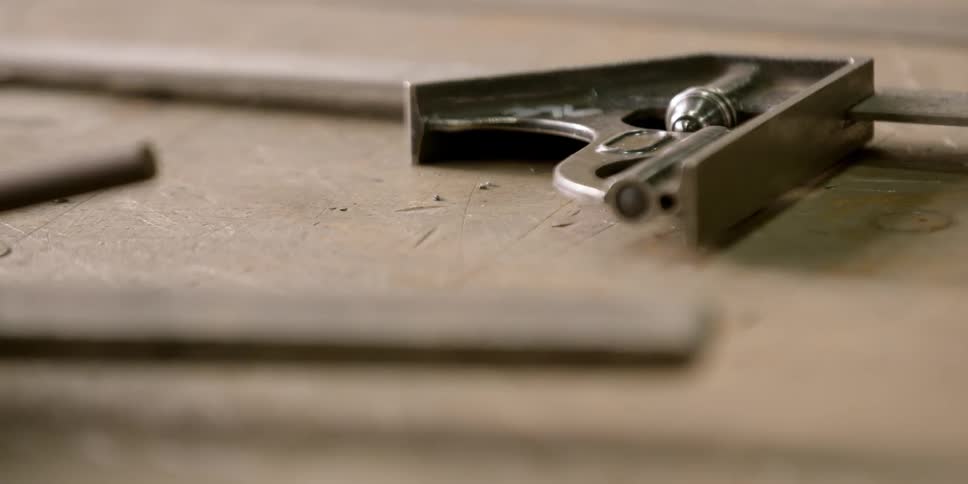 Hand tools and drill bits on a workbench