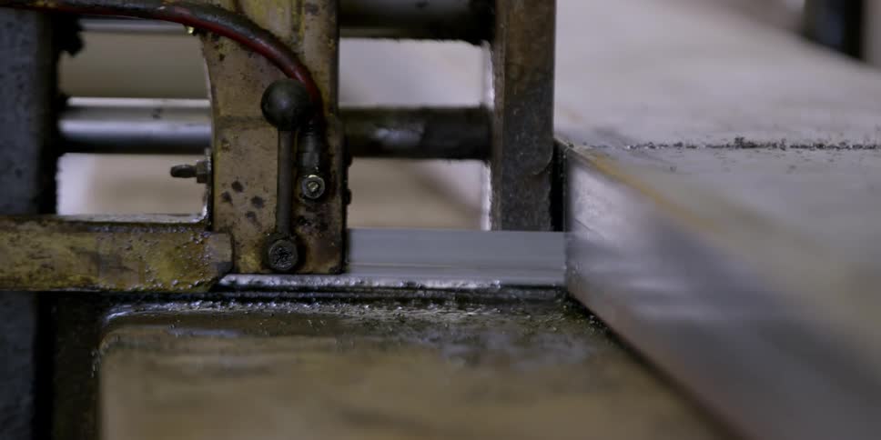 A saw cuts through a piece of material