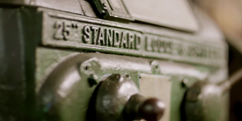 The side of a machine has writing stamped into the metal