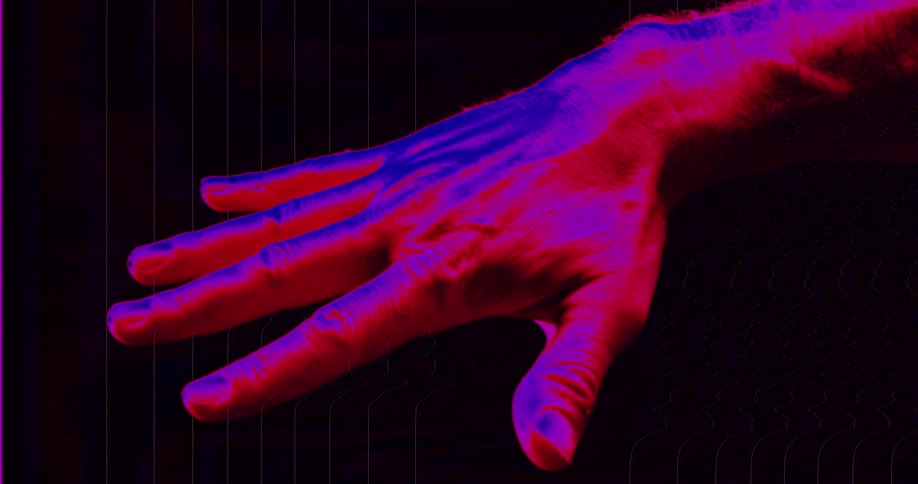 A glitchy animation shows a hand clenching and unclenching in a tense loop with a red and blue psychedelic color overlay