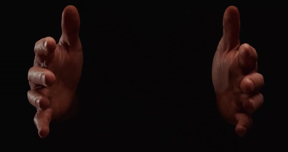 A pair of male hands dramatically emerge from a black background, slowly opening to reach out and then closing again