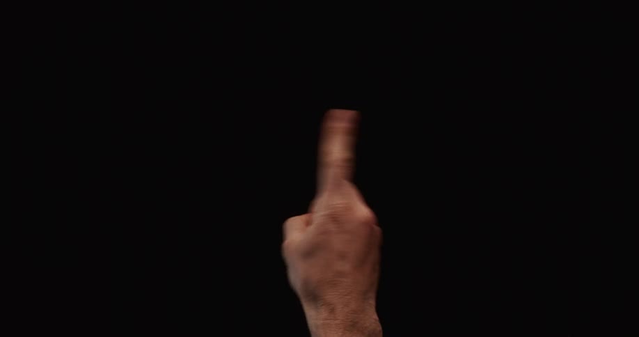 Close up of a male index finger wagging in disapproval on a black background