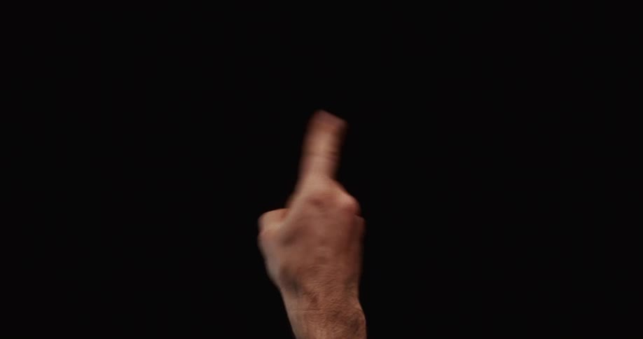 A male hand enters from the bottom of the frame and wags its index finger side-to-side in a "no" gesture against a black background