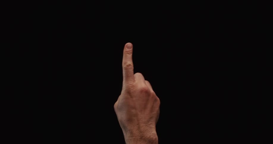A man's hand enters the frame wagging his finger back and forth against a black background