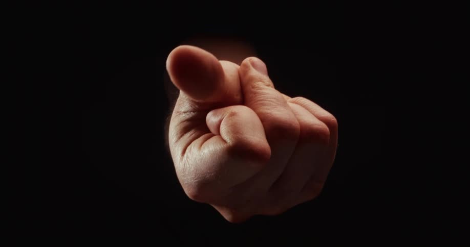 A hand emerges from the darkness and snaps fingers