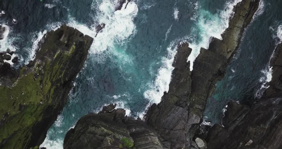 Waves crash against the rocks of this cliffside