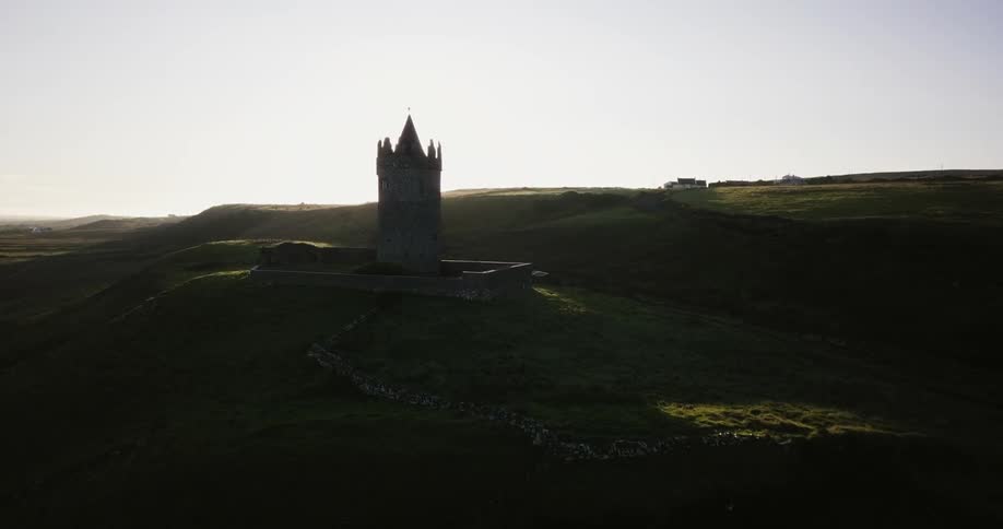 A tower sits on the dark hill ahead