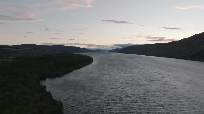 An aerial view shows the misty waters of Loch Ness in the Scottish Highlands at dusk