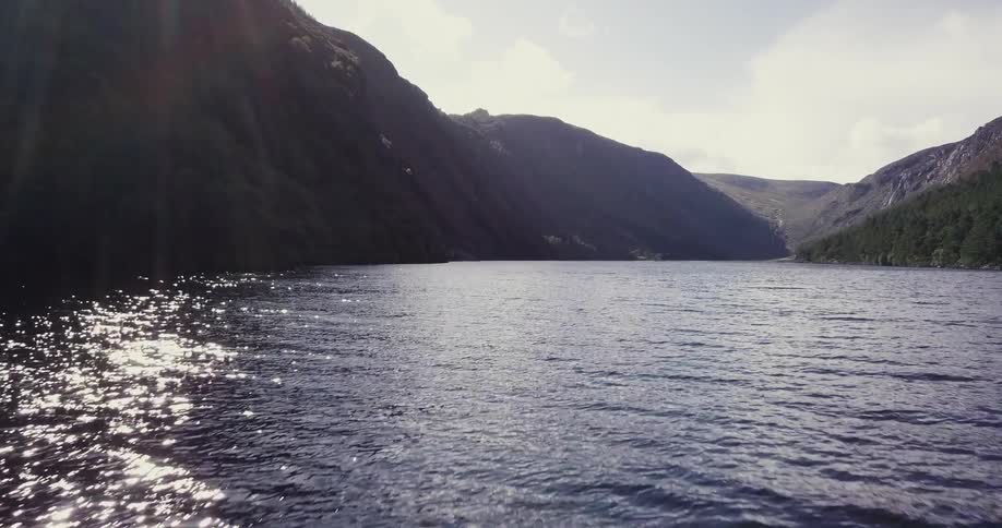 Sunlight shines on a rippling mountain lake
