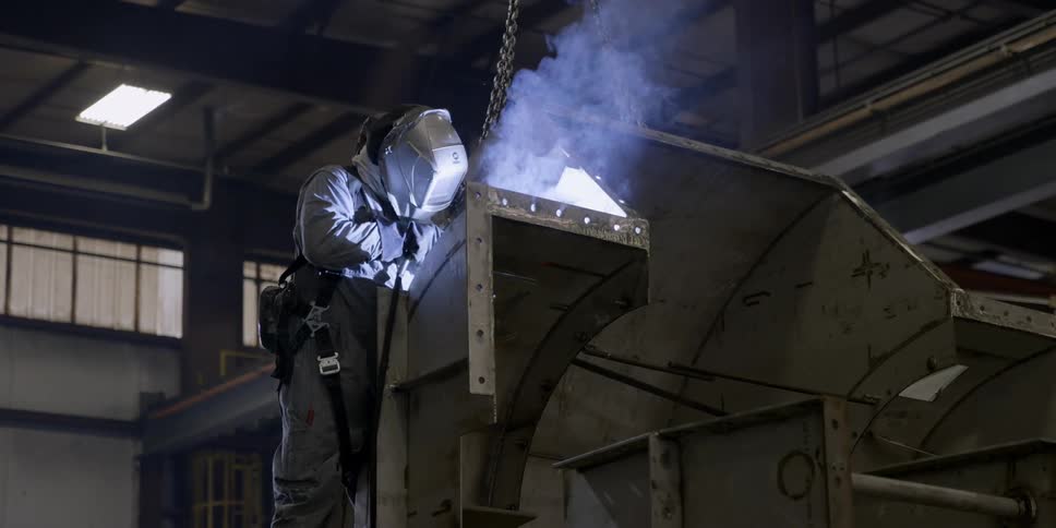 A welder works in a factory