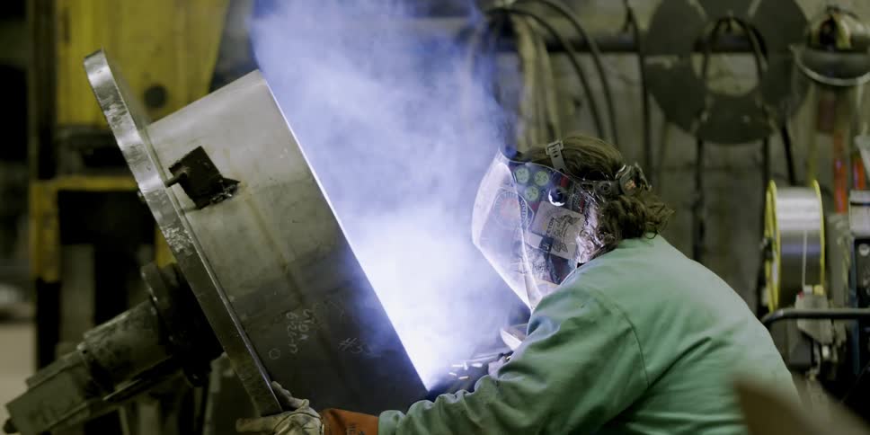 A man is welding in a shop