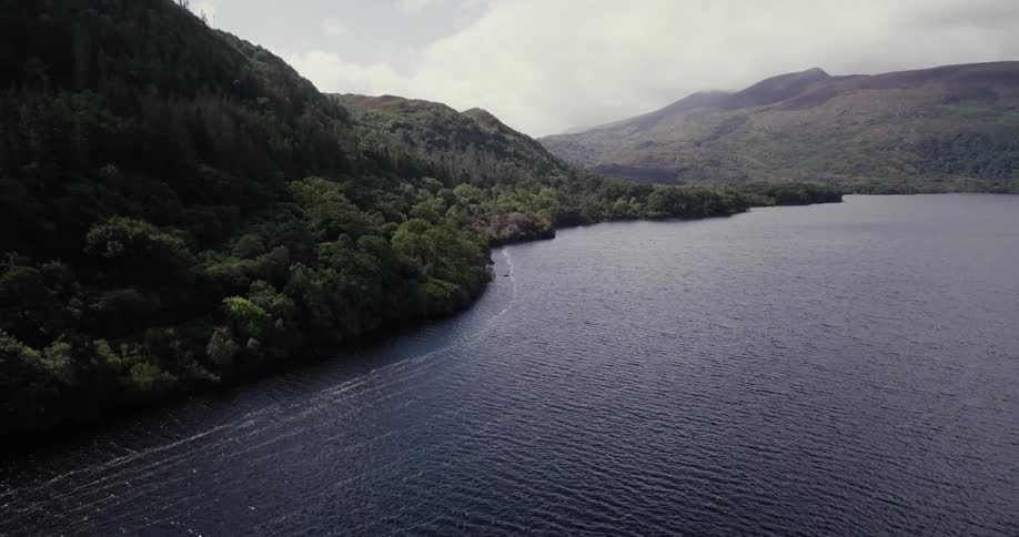 The water slowly goes towards the shore of the mountain