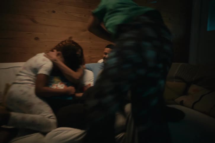 A loving family enjoys a cozy evening at home, reading a bedtime story together on the couch