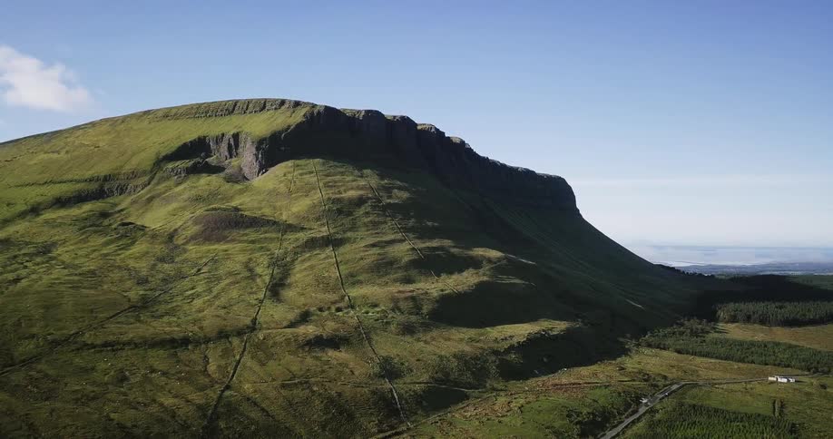 The tall hill is covered with grass