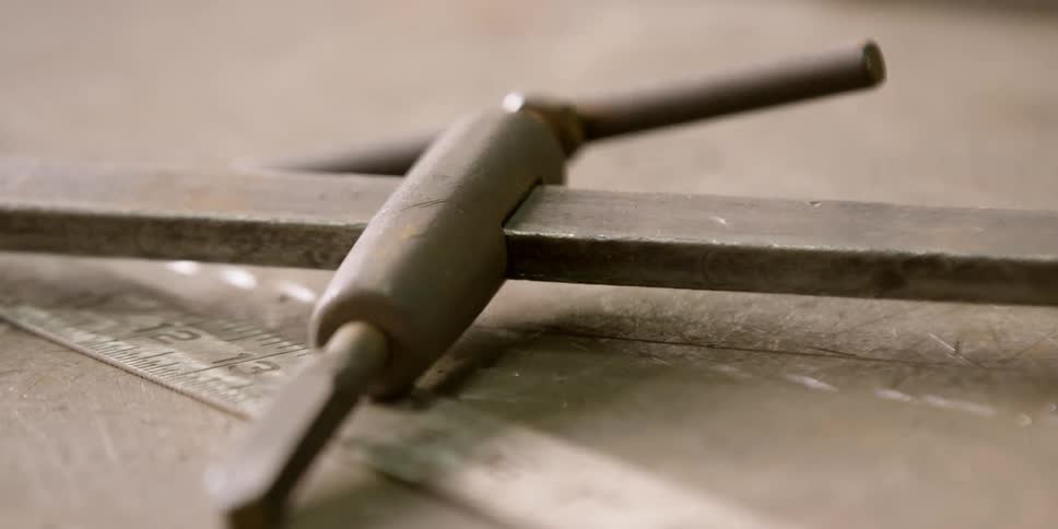 A metal tool sits on a table
