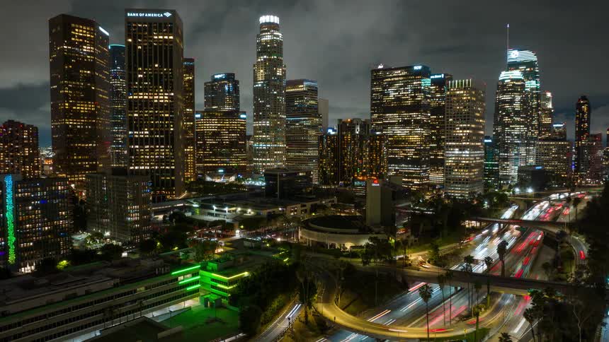 A stunning night timelapse shows the glowing skyline of downtown Los Angeles with streaks of light from traffic on the freeway