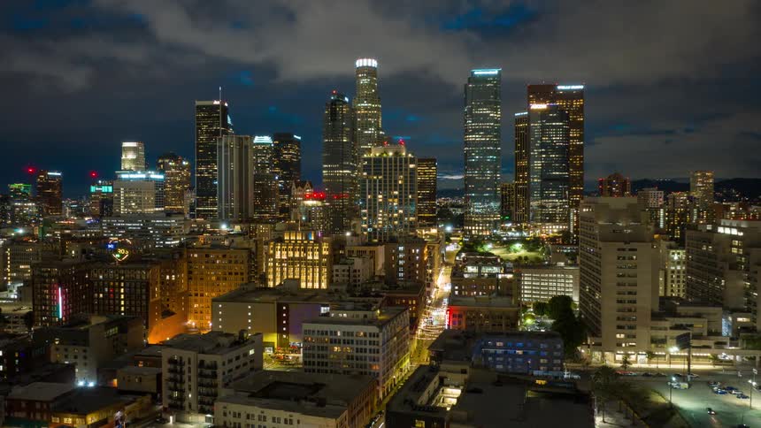 A captivating night timelapse showcases the vibrant energy of the Downtown Los Angeles skyline as clouds drift by