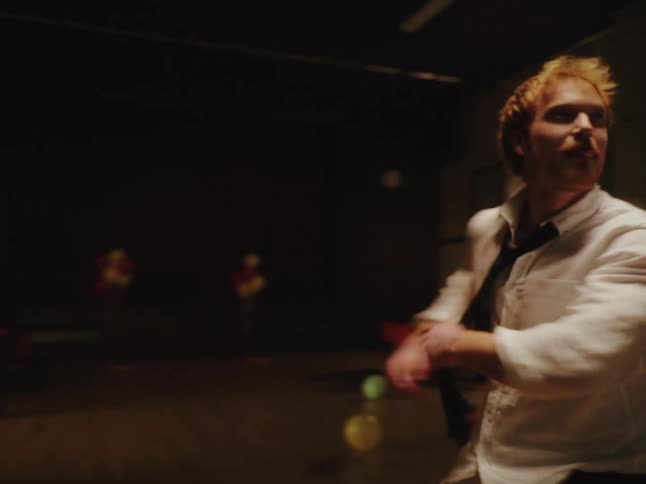 A young man dances alone with wild abandon in an empty party hall after everyone has left