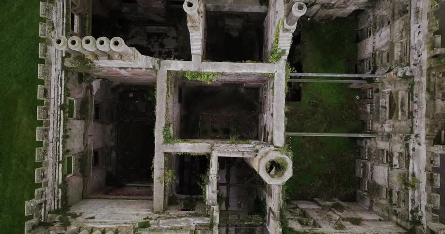 Birds fly around an abandoned building with no roof