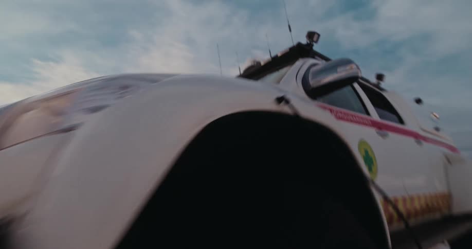 A convoy of Icelandic Search and Rescue super jeeps navigates a vast, snow-covered landscape in slow motion