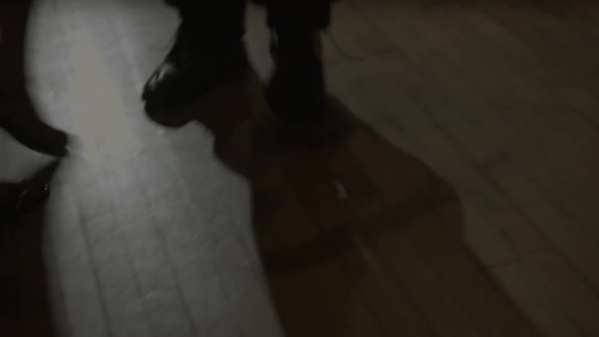 A woman with heels is dancing with someone