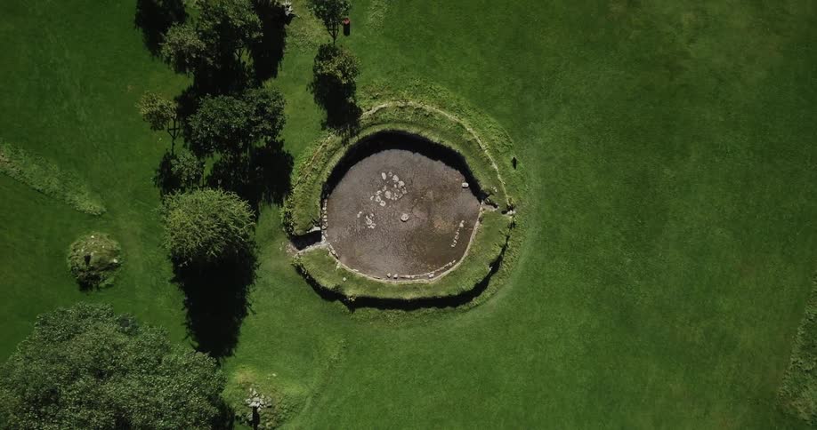 The green field has a circle with an entrance