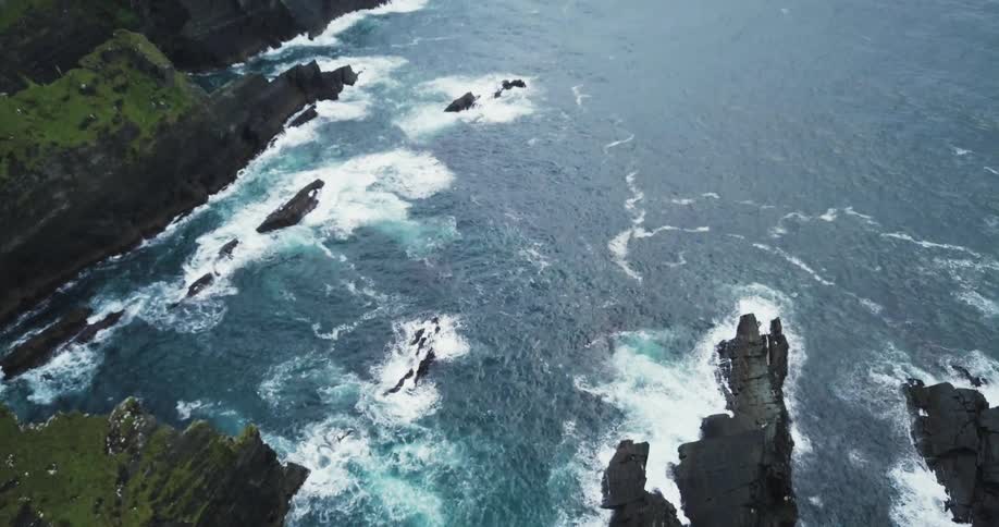Ocean waves flow around a rocky coast